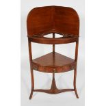 A George III mahogany corner washstand, with raised back, single drawer and shaped stretcher,