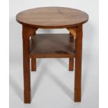An Arts and Crafts oak circular occasional table, with chamfered legs and a shelf,