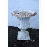A cast iron garden urn, of waisted form with fluted decoration,