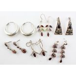 A collection of six pairs of drop earrings of variable designs. Most are marked 925 for silver.