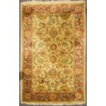 An Indian carpet, with scrolling foliage and tendrils inside a triple border,