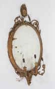 A gilt wood and gesso girandole, probably 19th century, the oval plate above three scrolling lights,