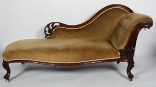 A Victorian walnut framed chaise longue, with buttoned scroll arm and serpentine seat,