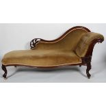 A Victorian walnut framed chaise longue, with buttoned scroll arm and serpentine seat,