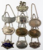 A group of ten vintage silver plate and pewter decanter labels, including Gin,