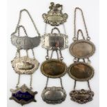 A group of ten vintage silver plate and pewter decanter labels, including Gin,