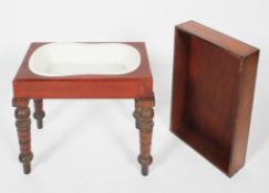 A 19th century walnut bidet, with original ceramic pan,