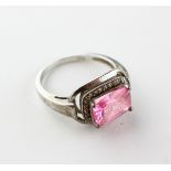 A white metal dress ring principally set with a pink cubic zirconia