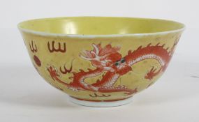 A Chinese yellow ground bowl, circa 1900, with iron red dragons chasing pearls,