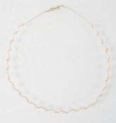A yellow metal wire collar necklace having inter-spaced pairs of freshwater pearls. Trigger clasp.