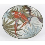 A Studio pottery stoneware charger, of circular form, painted with parrots in trees,