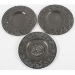 A pair of Arts and Crafts style pewter mounted copper dishes, with flowering foliage decoration,