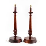 A pair of mahogany table lamps, carved as Corinthian columns on circular bases,