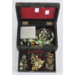 A vintage jewellery box containing a selection of costume jewellery,