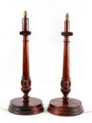 A pair of mahogany table lamps, carved as Corinthian columns on circular bases,