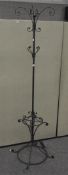 A modern wrought iron metal coat and umbrella stand,