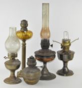 A group of five oil lamps,of varying sizes and conditions,