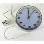 A vintage Metamec wall clock, light blue in colour, with Arabic numerals denoting hours,