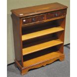 A modern yew wood bookcase, with three shelves under two drawers,