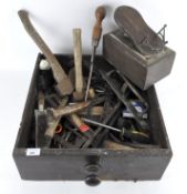 A tray containing a variety of vintage tools, including a mallet, axe,
