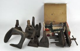 A group of mixed metalware, including iron door stops, a vice,