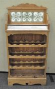 A stripped pine wine rack with marble top, 123cm high,