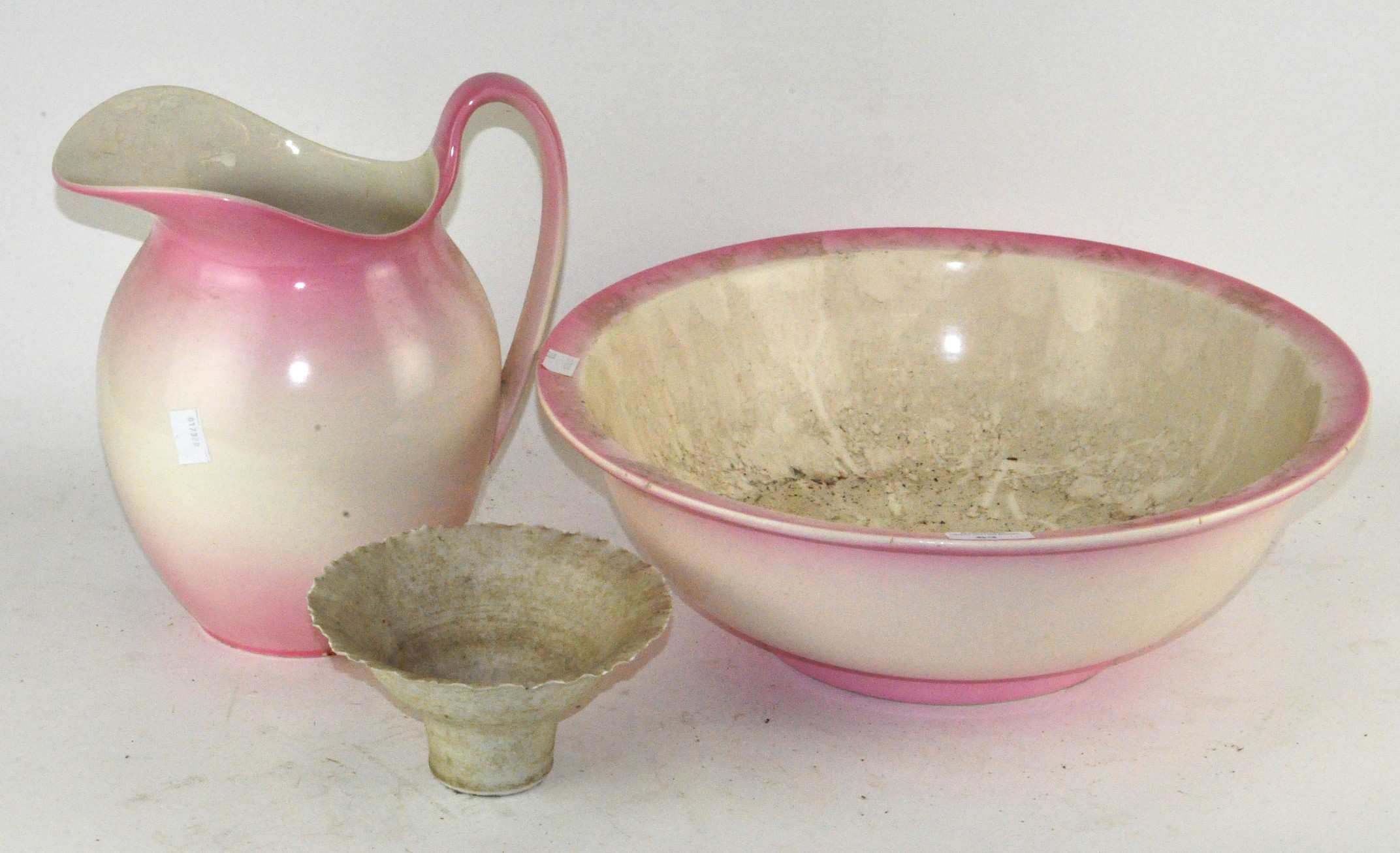 A vintage pink wash bowl and jug,