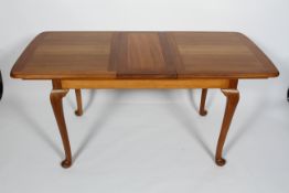 A 20th century refectory table, on cabriole legs and pad foot, possibly walnut,