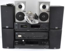 A collection of music equipment, including NAD stereo cassette deck 613, Kenwood CD player,