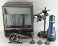 A collection of scientific equipment,including a Release-o-Matic set of scales, a cathode ray tube,