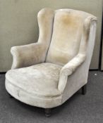 A 19th/20th century Howard style Chesterfield low armchair, raised on turned front legs,