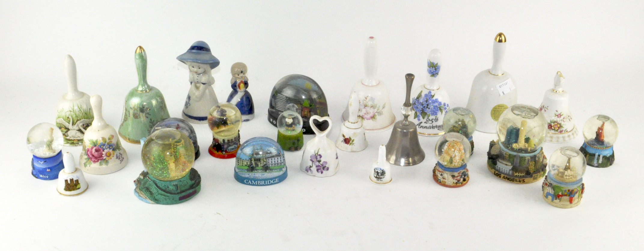 A collection of assorted ceramic bells and snow globes