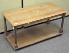 A 20th century oak coffee table, of rectangular form, raised on four bun feet,