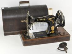 A vintage Singer sewing machine in original carry case