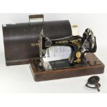 A vintage Singer sewing machine in original carry case