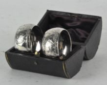 A pair of Edwardian silver napkin rings, with highly detailed foliate decoration,