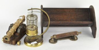 A novelty brass model of a canon, together with a musical brass bird cage,