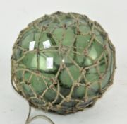 A vintage glass fishing float, of globular form,