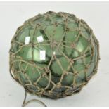 A vintage glass fishing float, of globular form,