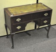 A 20th century mahogany and leather topped knee hole desk of small proportions,