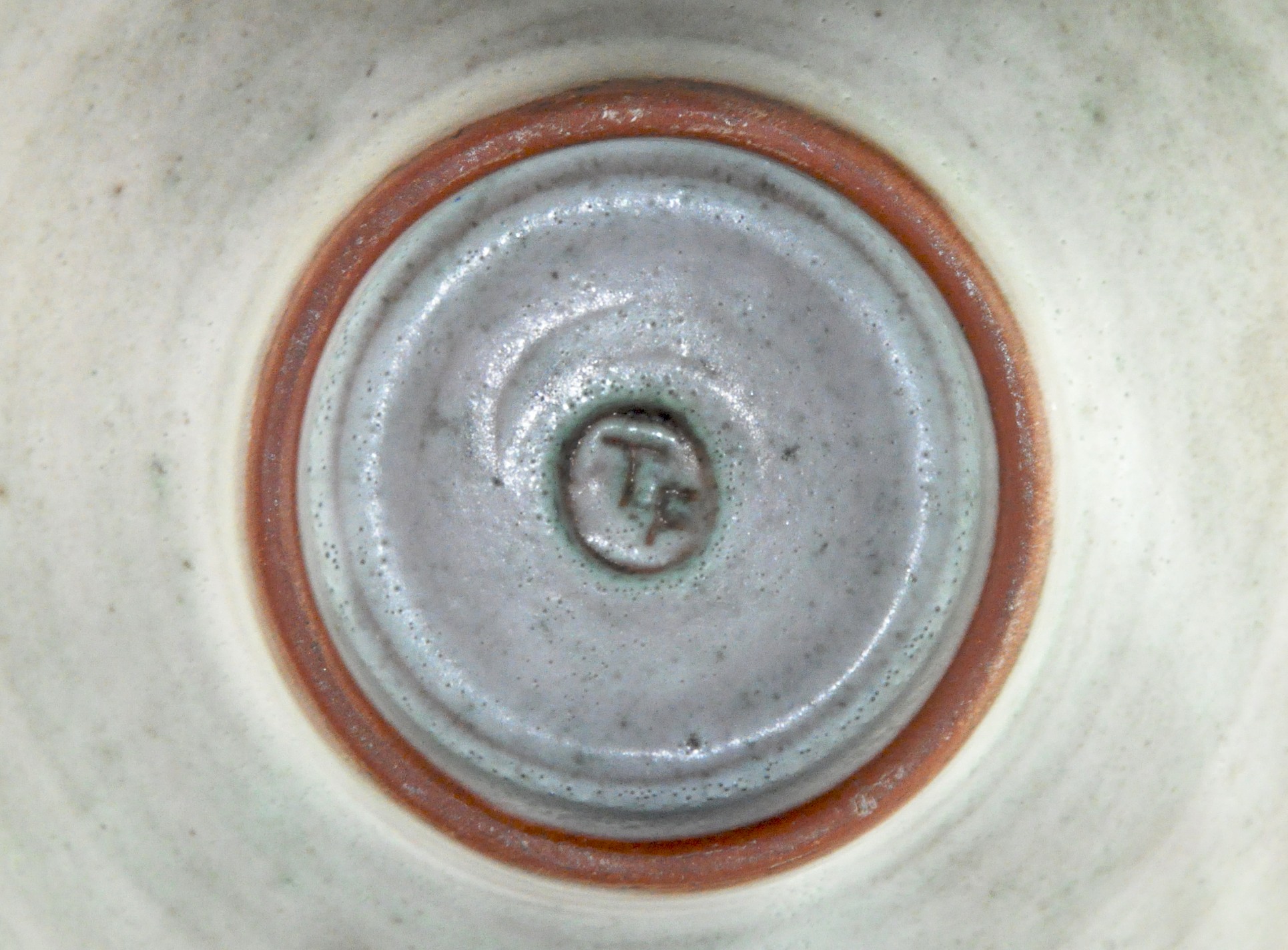 An Art pottery bowl with abstract fish decorated to the inside, marked to base 'TF', 16. - Image 2 of 2