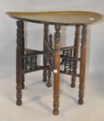 A Middle Eastern brass tray top table, with folding base,