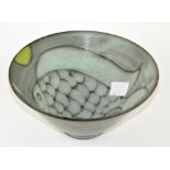 An Art pottery bowl with abstract fish decorated to the inside, marked to base 'TF', 16.