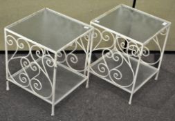 A pair of metal and glass square garden side tables,
