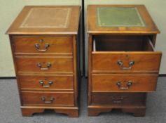 A pair of reproduction walnut filing cabinets with gilt tooled leather tops,