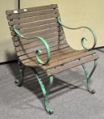 An early painted iron and wooden slatted single seater bench,