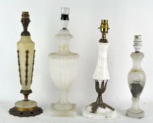 Four vintage stone table lamps, two adorned with metal decoration,