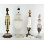 Four vintage stone table lamps, two adorned with metal decoration,