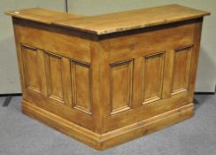 A 20th century bespoke pine reception counter/drinks bar with panelled fronts,