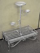 A silver painted metal conservatory three tier plant stand,